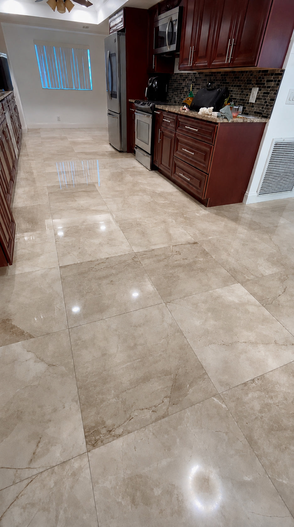 Cream marble kitchen floor with an even polished finish and clear light reflections.
