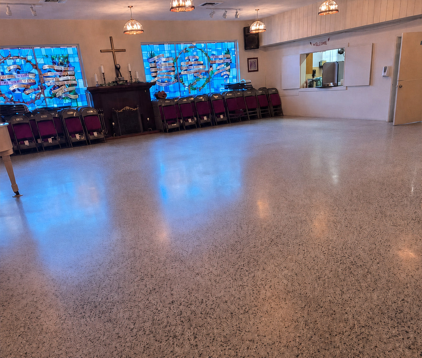 Large terrazzo hall floor with a dull, low-reflection finish before polishing.
